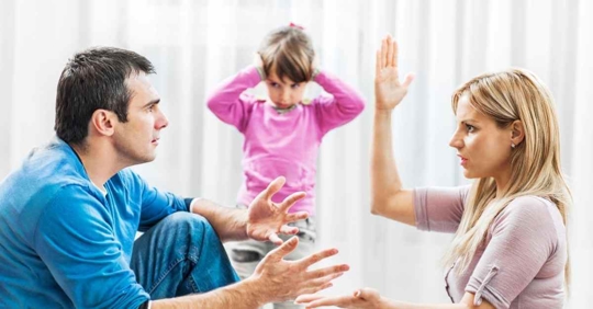 A father and mother arguing while their daughter, who is in the middle, covers her ears