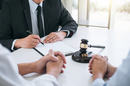 divorcing couple consulting with a lawyer
