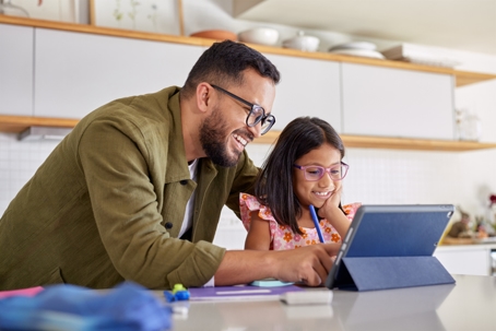 father helping daughter with homework