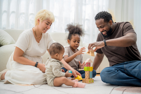 couple playing with children and blocks