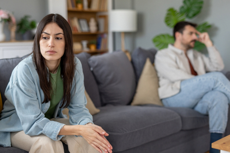 frustrated couple sitting on a couch
