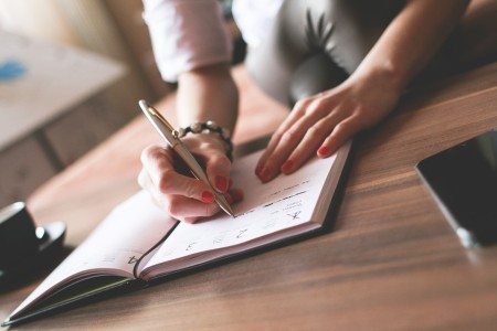 woman signing prenup in ohio divorce